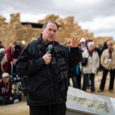 Man standing in front of crowd speaking into microphone