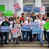 A group of people holding signs that read "Vote No on Prop 8"
