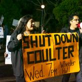 Two students holding a banner that says "Shut down Coulter. Wed 7 PM Wheeler Hall."